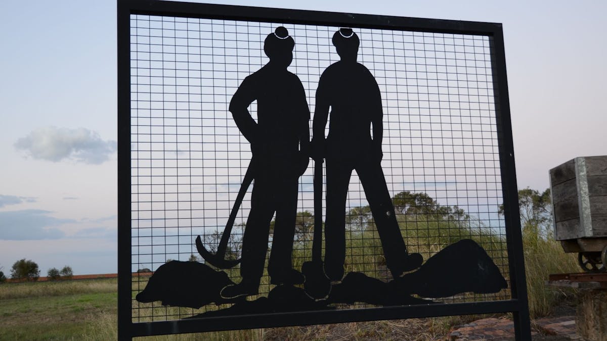 Silhouette of two miners Silhouette of two miners