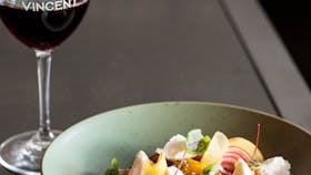 Dish of modern food with a glass of red wine