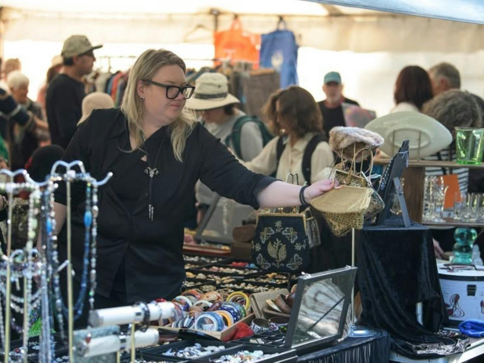 Shoppers browse a vintage retail stores with jewellery, bags, vases