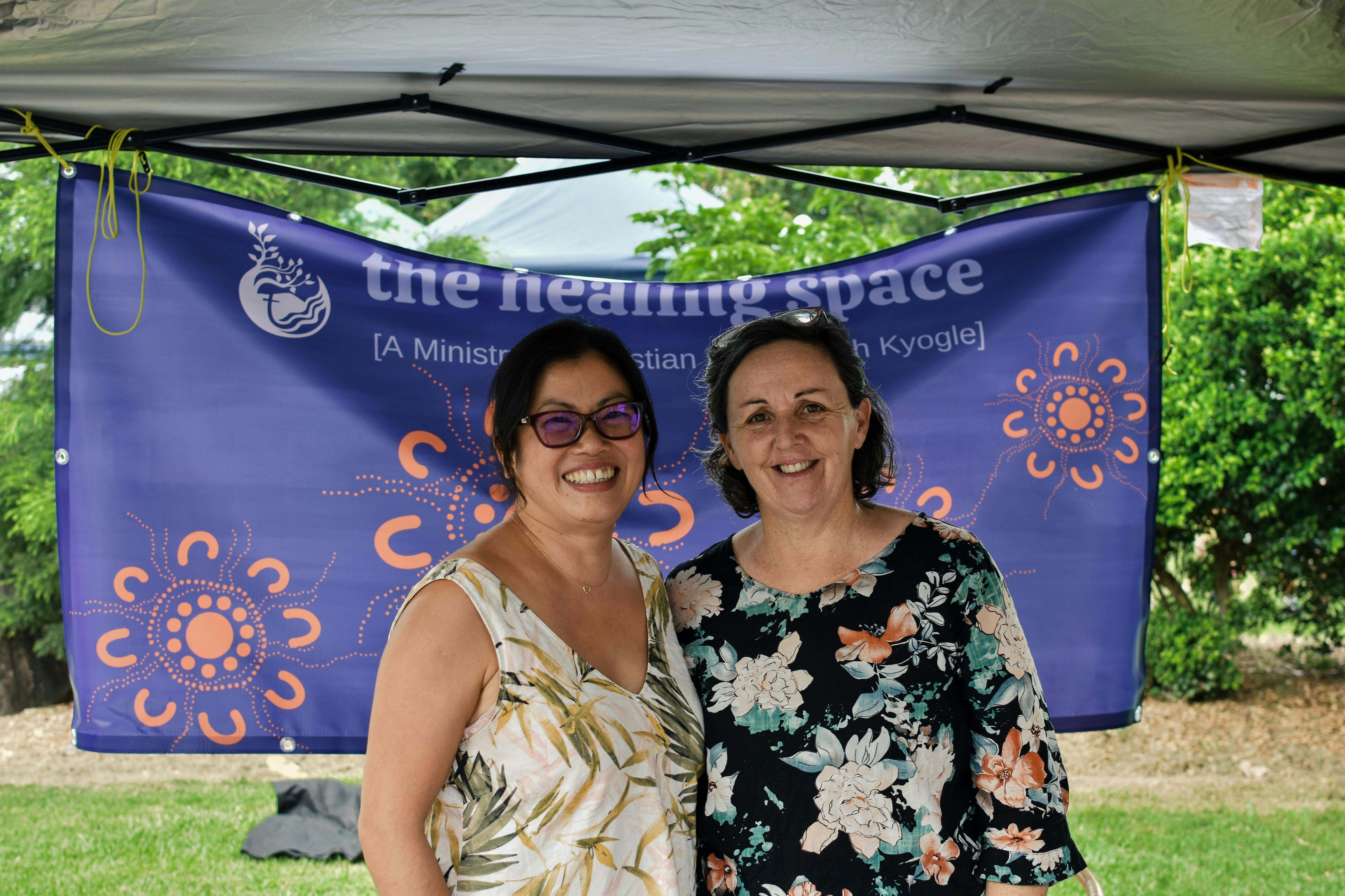 @ lovely ladies in front of a banner from their community group