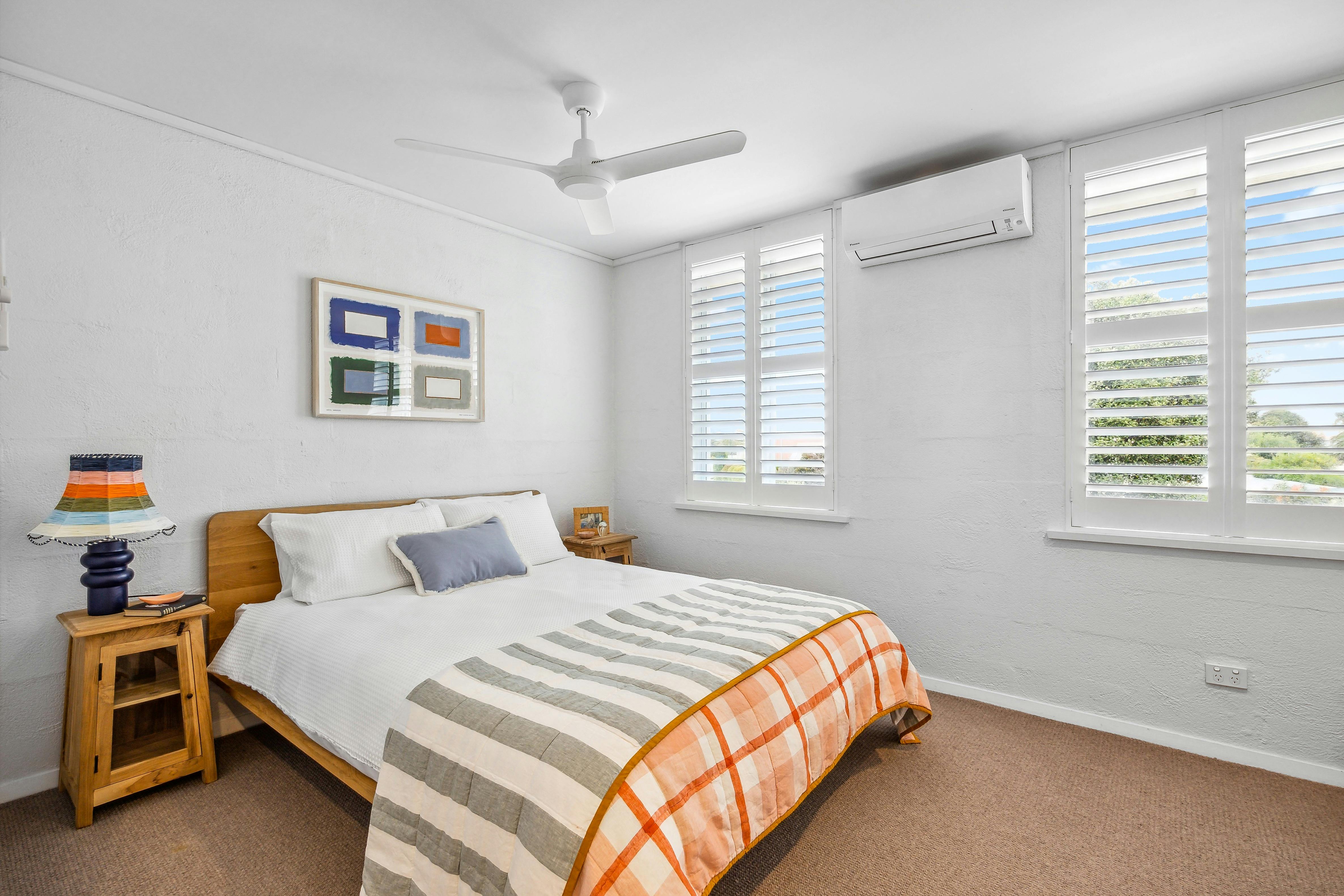 Bedroom 2 with a queen bed and built in wardrobes