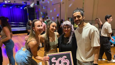SOS X MoveMe with guest instructors.- 4 people holding the SOS blackboard.