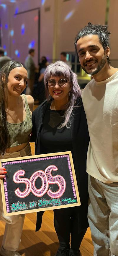 SOS X MoveMe with guest instructors.- 4 people holding the SOS blackboard.