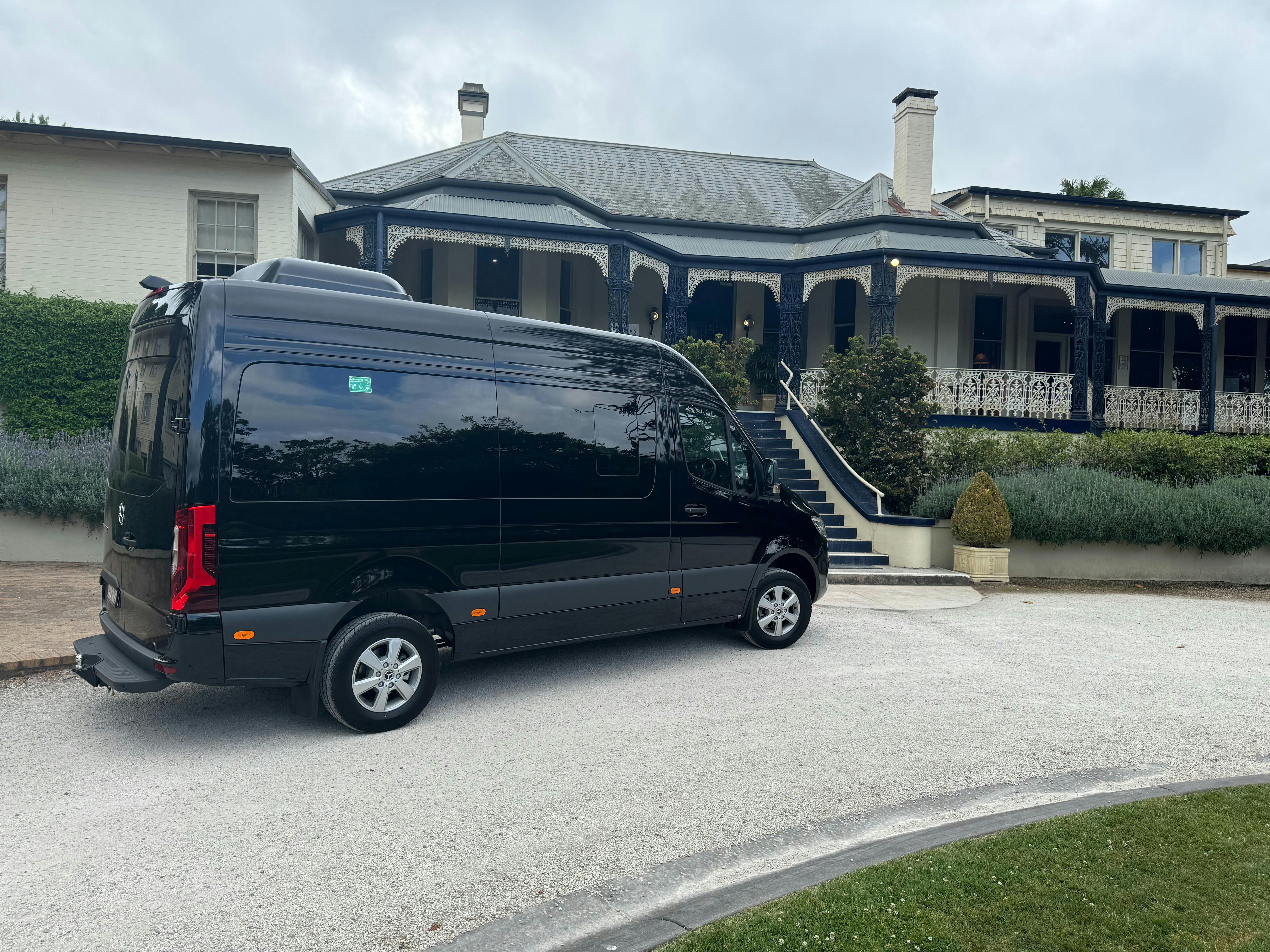 High-top Mercedes Sprinter Mini Bus parked in a scenic location, offering comfortable seating for up