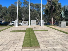 Lawn field in shape of a cross centred in the tiled area of the Shepparton Cenotaph