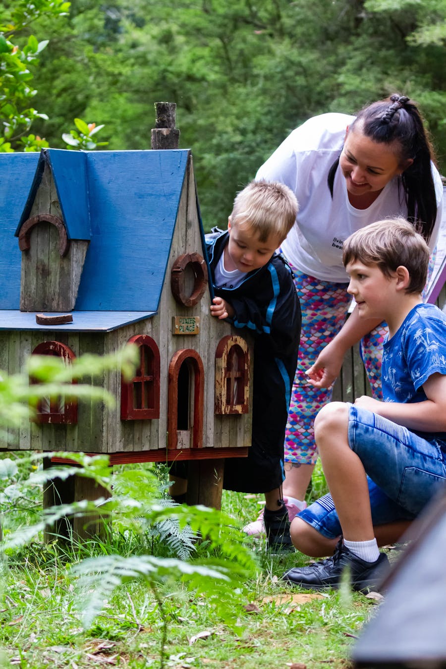 Family looking into fairy houses at Illawarra Fly