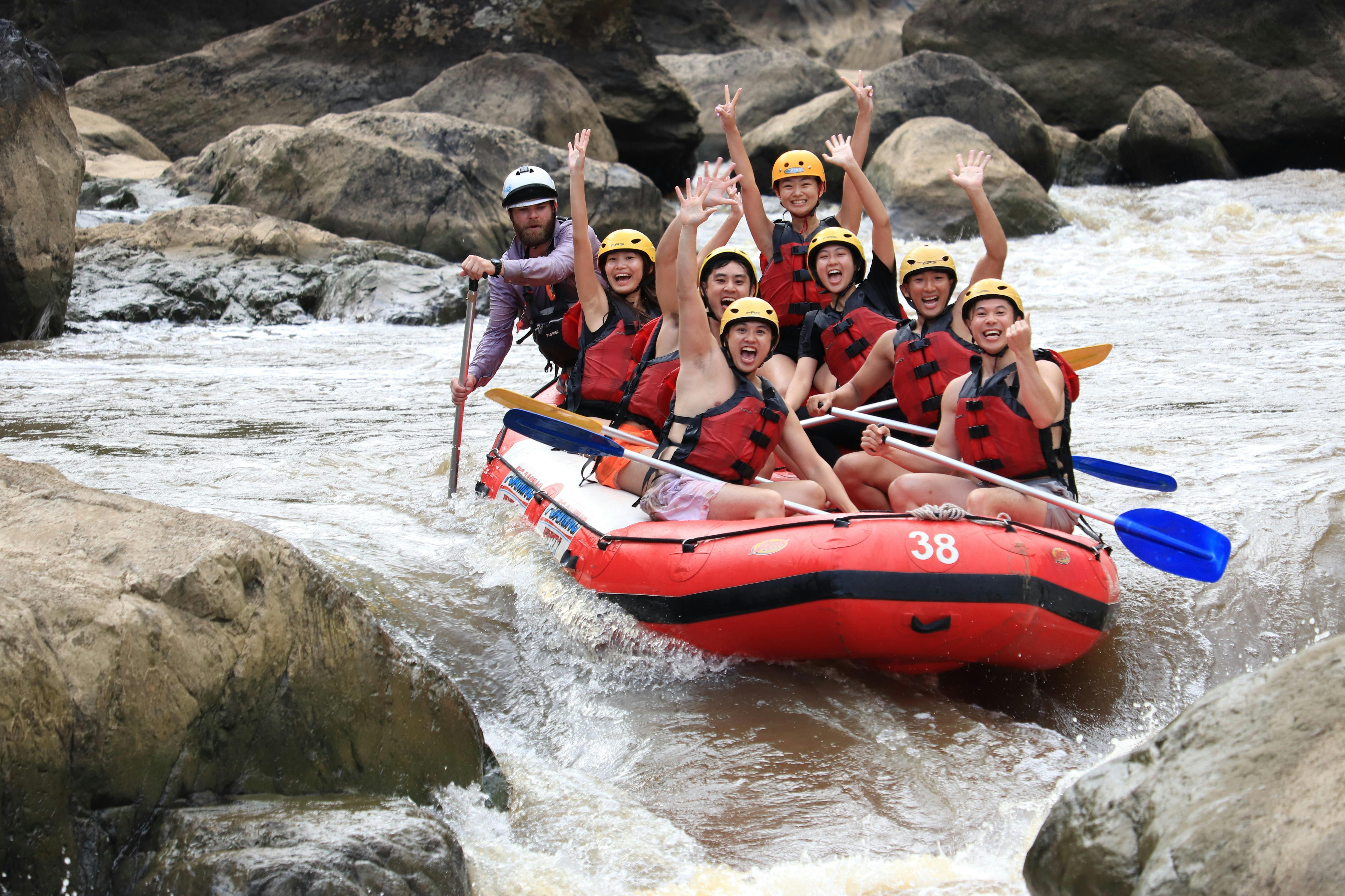 Group of White Water Rafters Waving on the Barron River in Tropical North Queensland