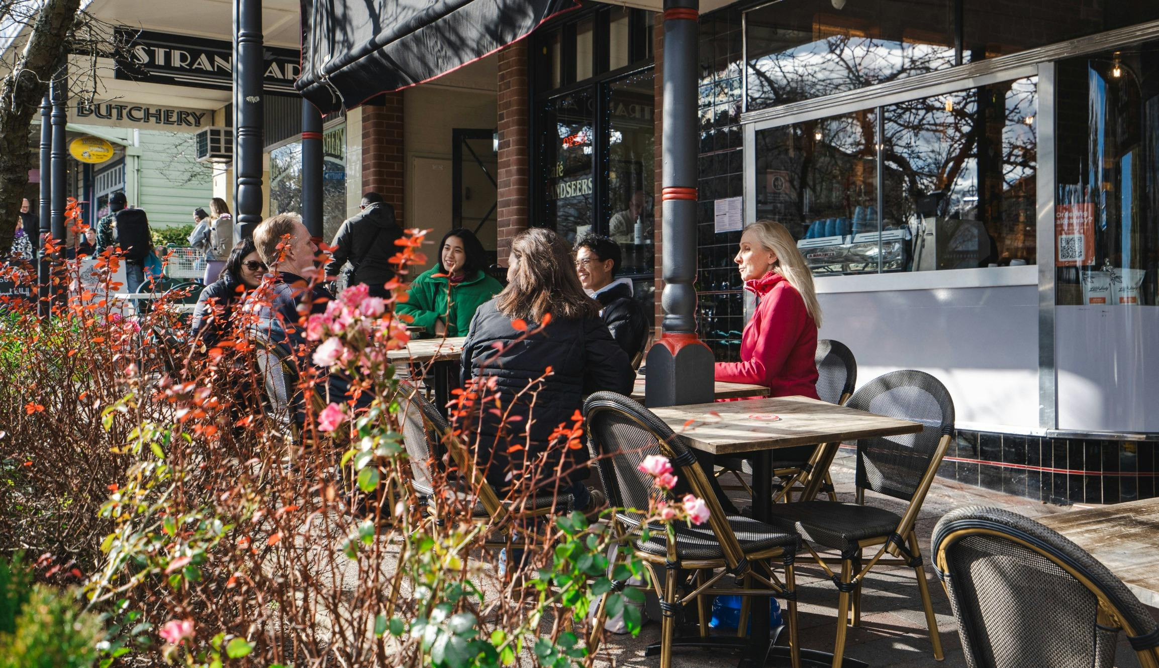 Tourists dining at outdoor cafe table in Leura mountain village