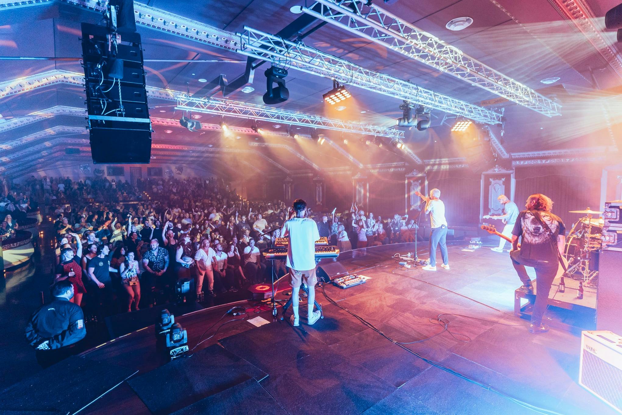 act on stage performing to crowd