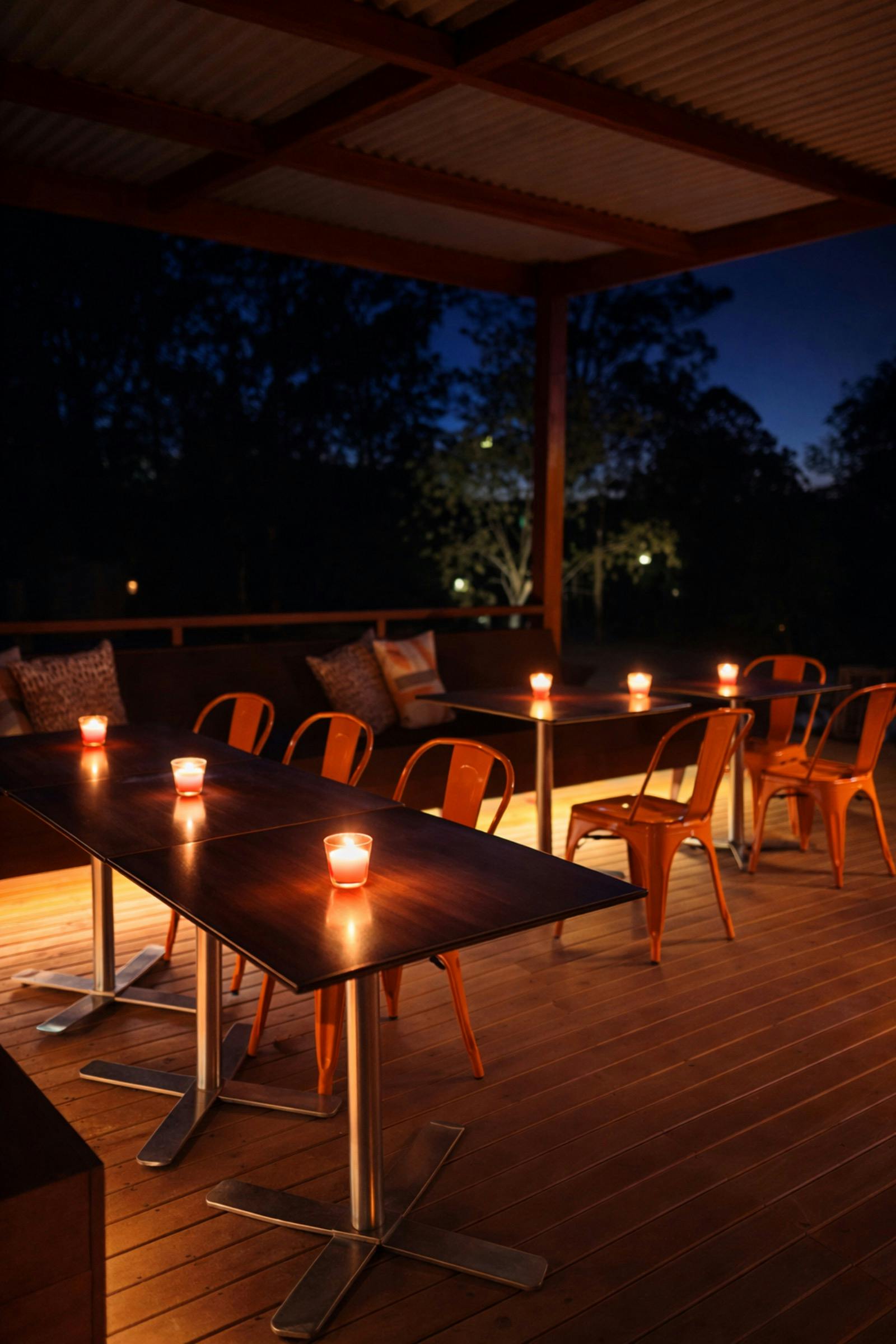 Outdoor seating area with tables and orange chairs on a big deck