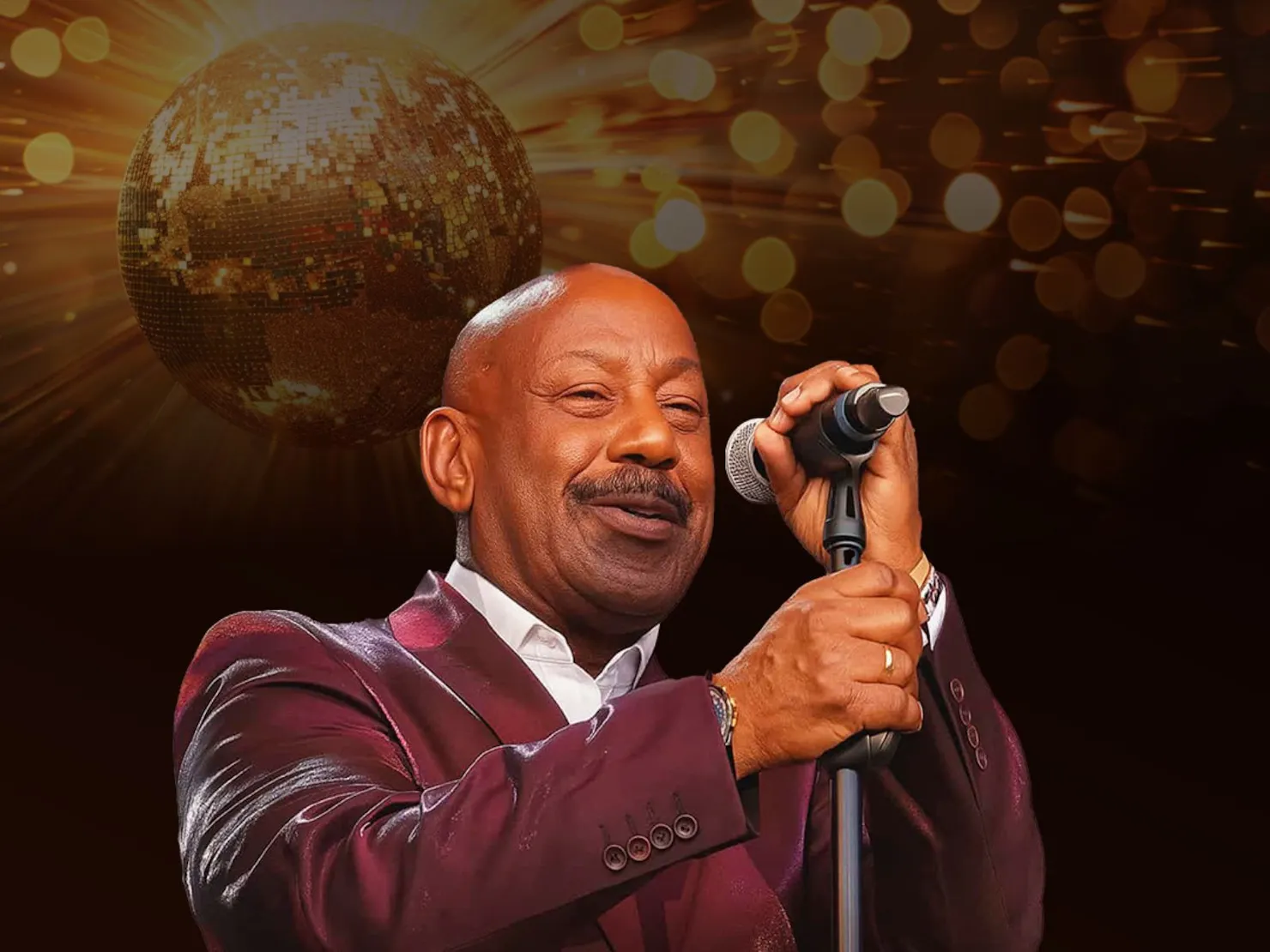 Kennie with a microphone stand in front of him