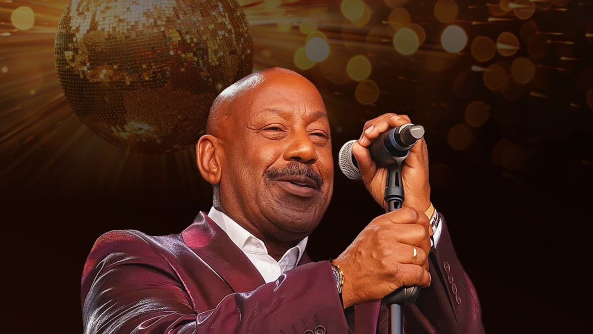 Kennie with a microphone stand in front of him