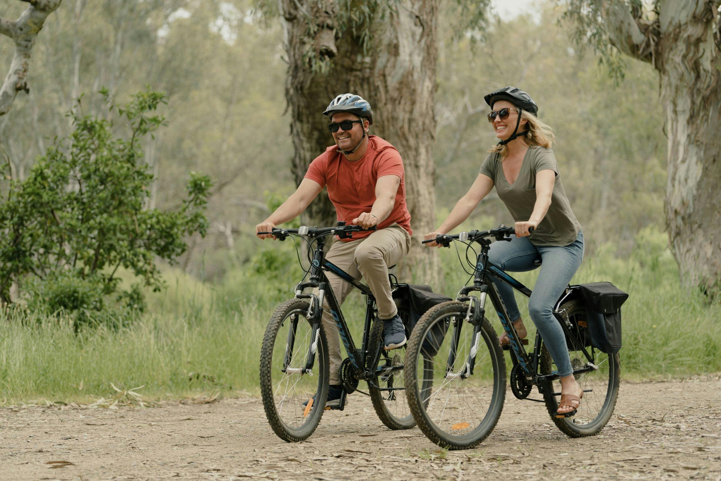 couple riding bikes along the foreshore in Howlong
