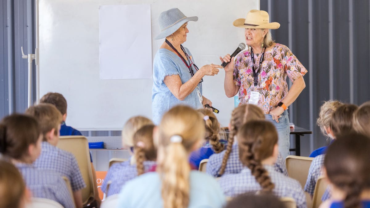 Two storytellers speaking to primary students at a session