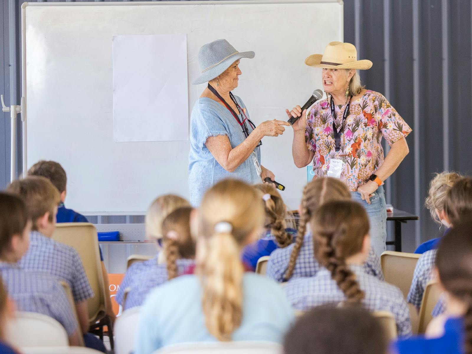 Two storytellers speaking to primary students at a session Two storytellers speaking to primary students at a session