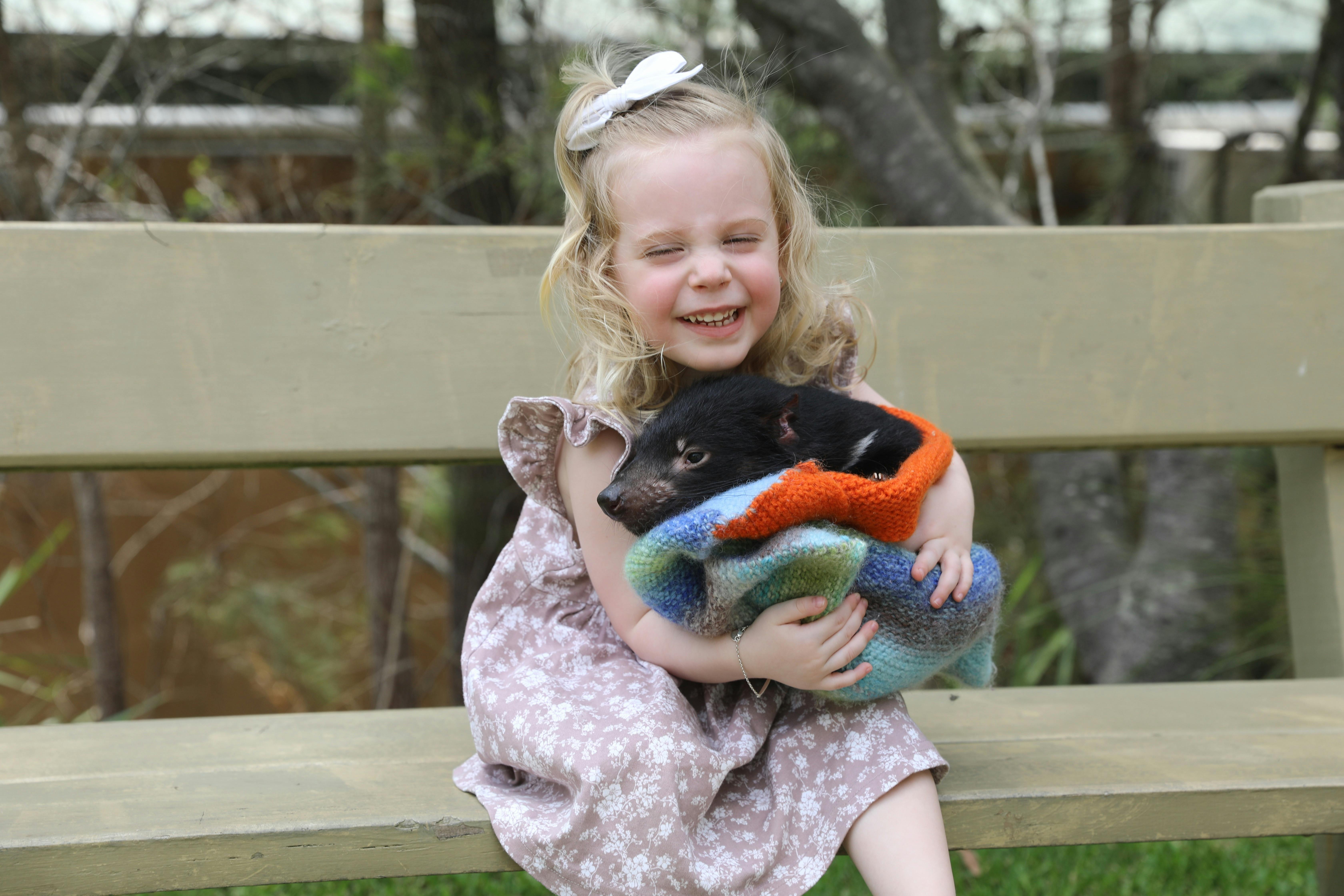 Girl holding Tasmanian devil joey