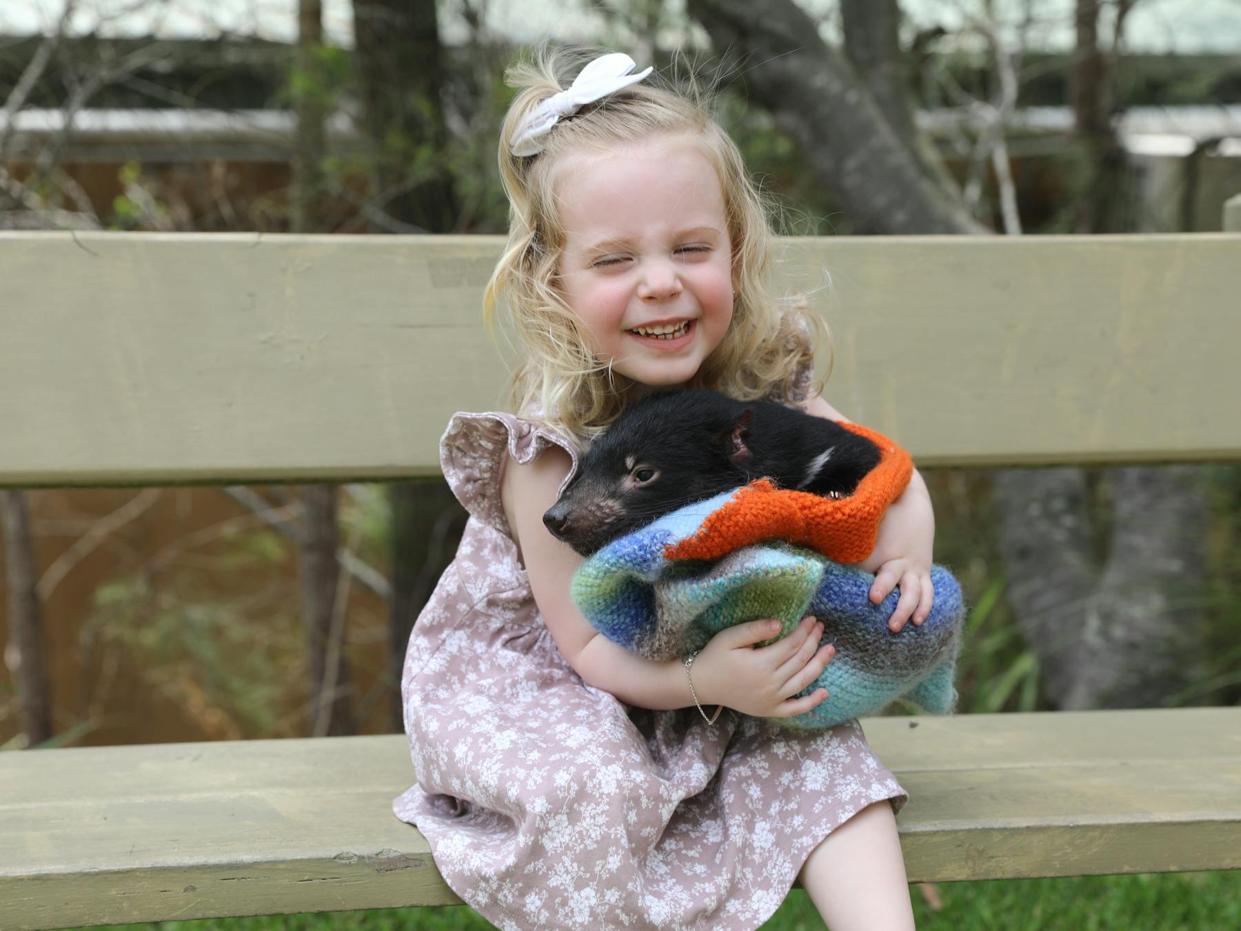 Girl holding Tasmanian devil joey