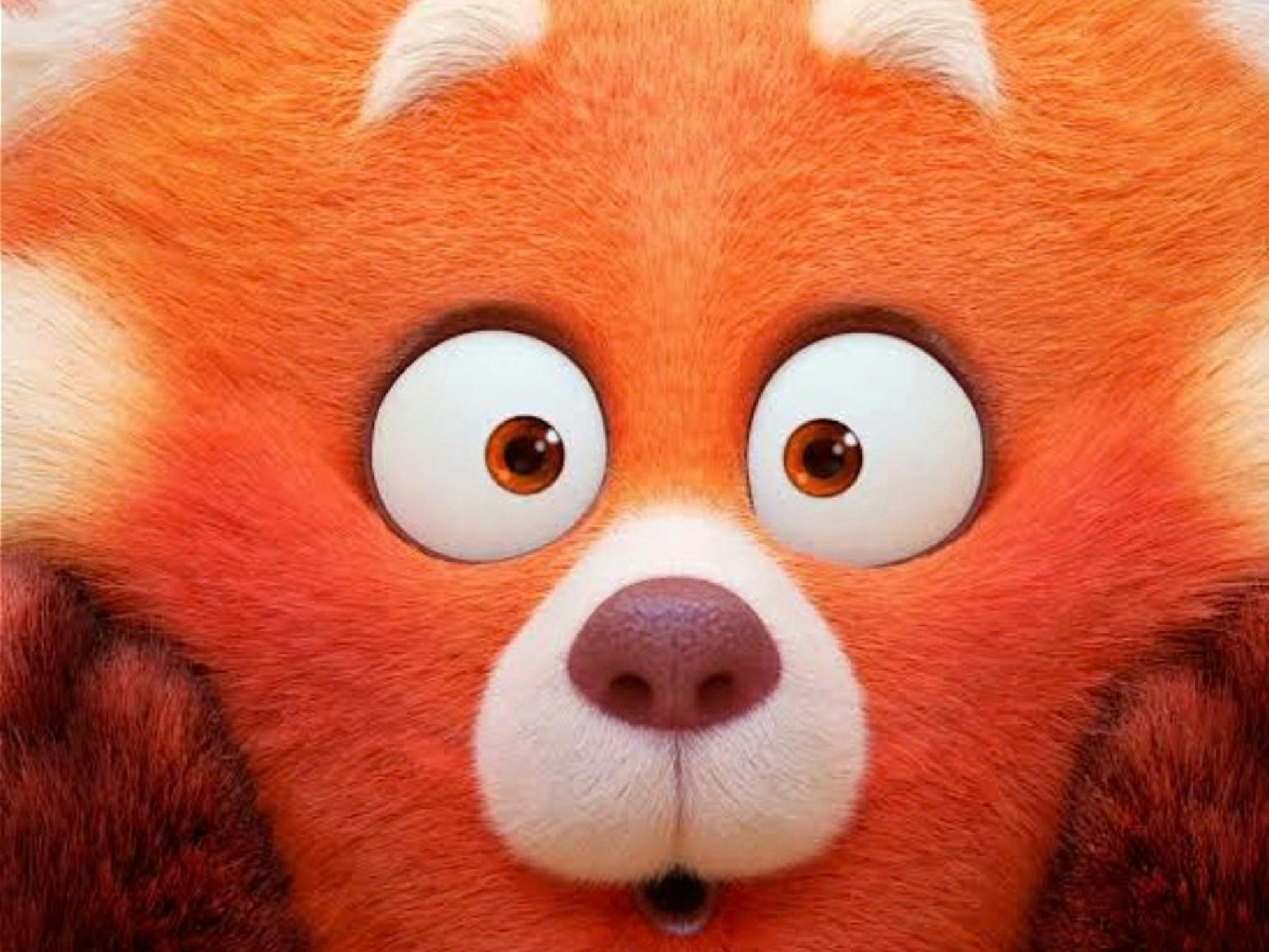 Still from Pixar's Turning Red, showing the red panda hugging 3 teenage girls in a pink bedroom.