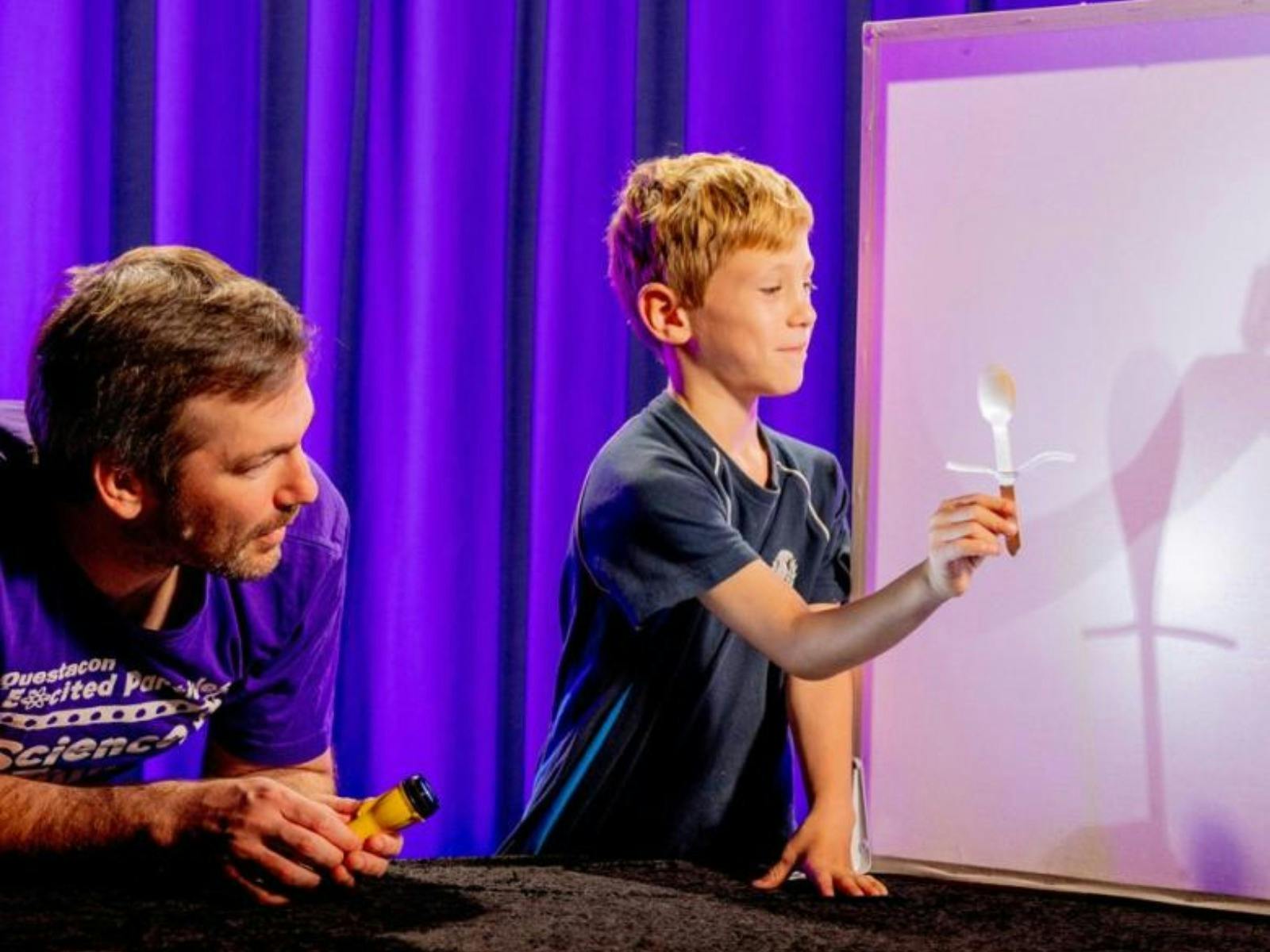 A man and a young boy exploring light in Science Time