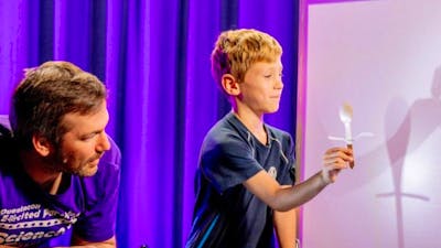 A man and a young boy exploring light in Science Time