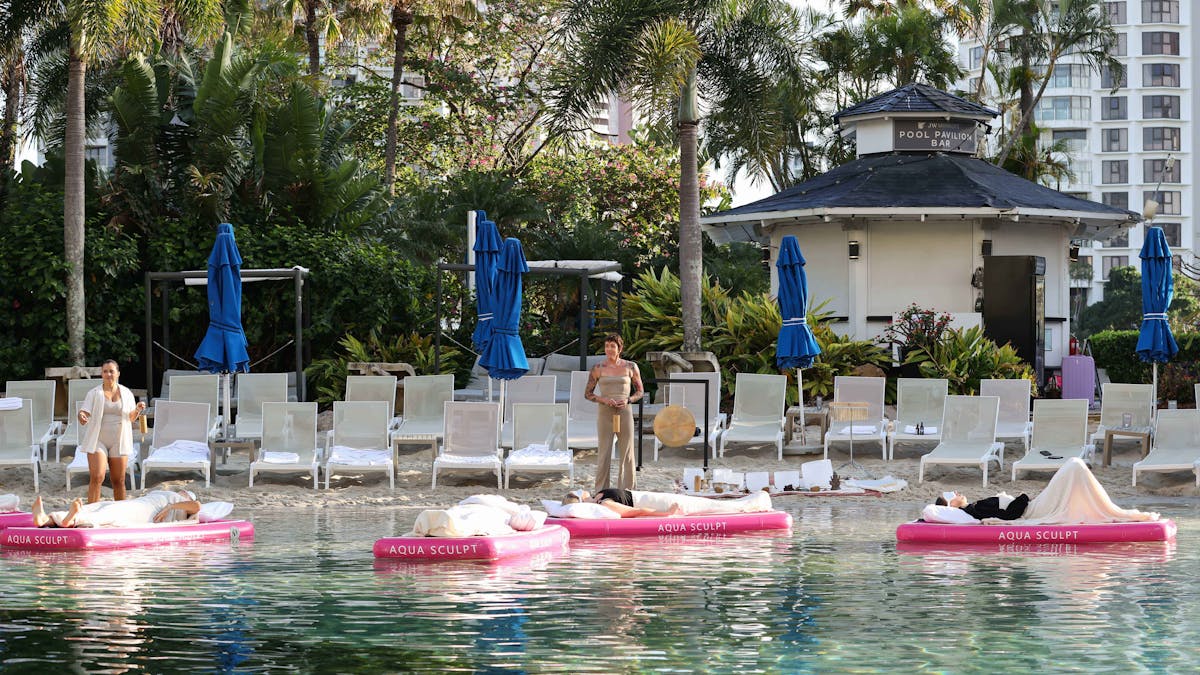 Aqua Sculpt sound bath practitioner in the outdoor pool area at the JW Marriott in Gold Coast