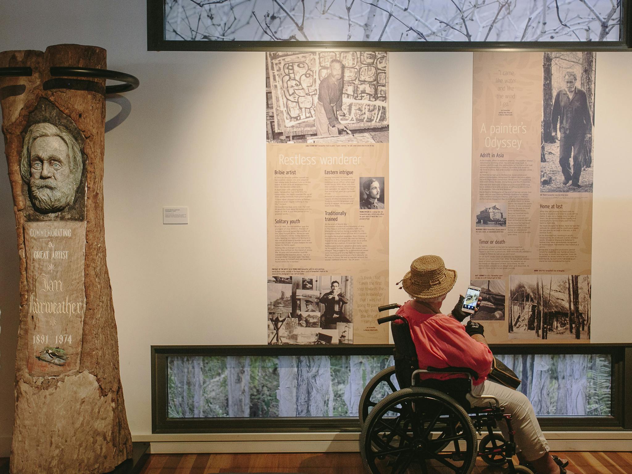 Woman in wheelchair viewing Fairweather exhibition
