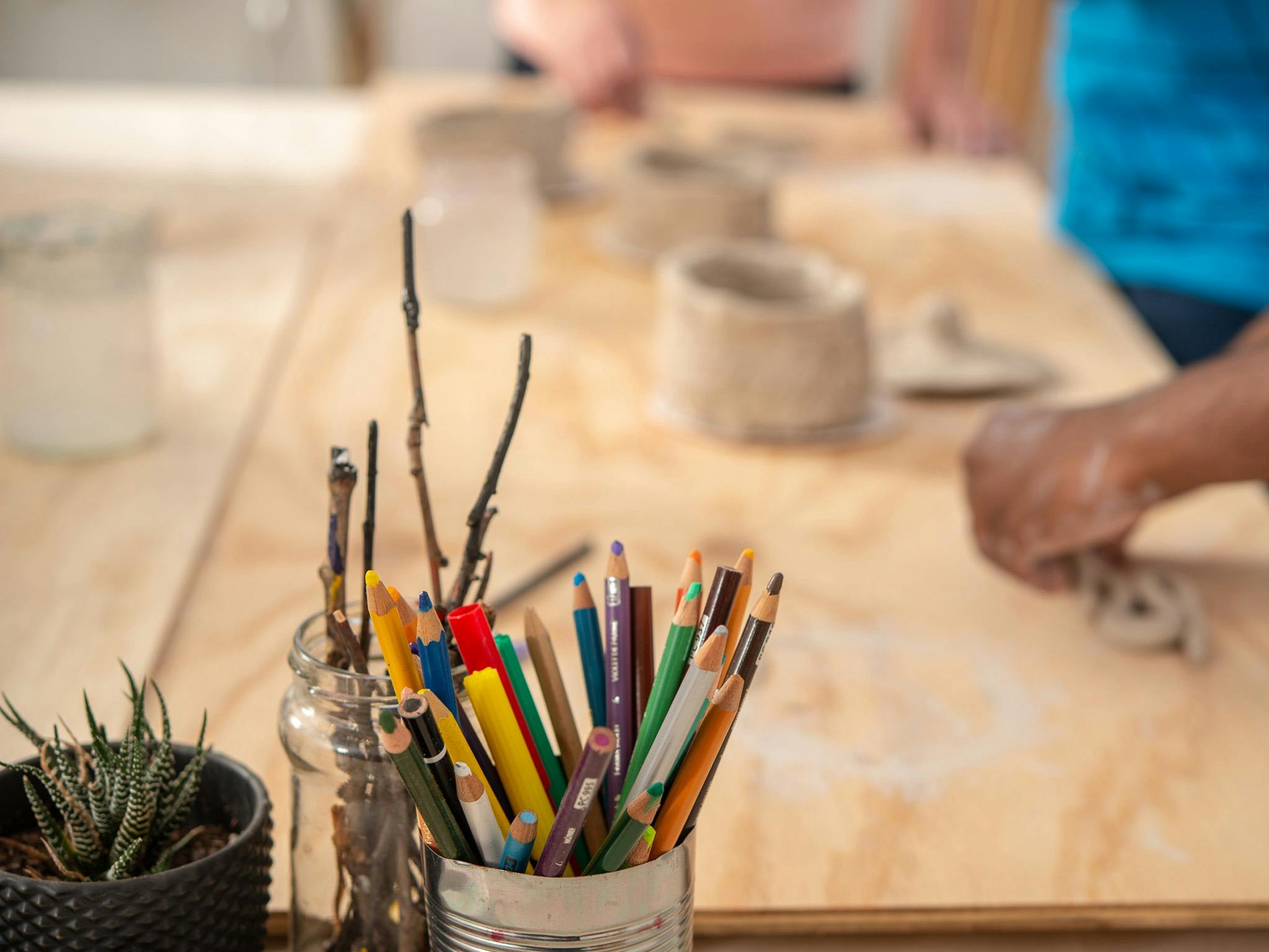 Clay, twig brushes, pencils in tin