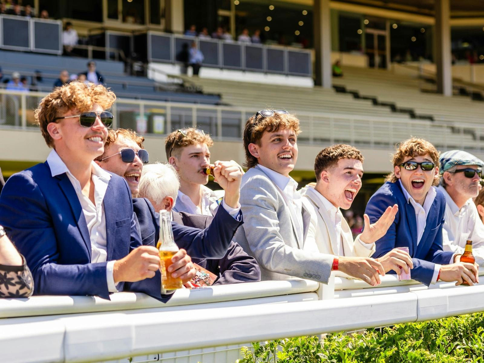 Racegoers enjoy a win during the Ladbrokes Spring Racing Carnival