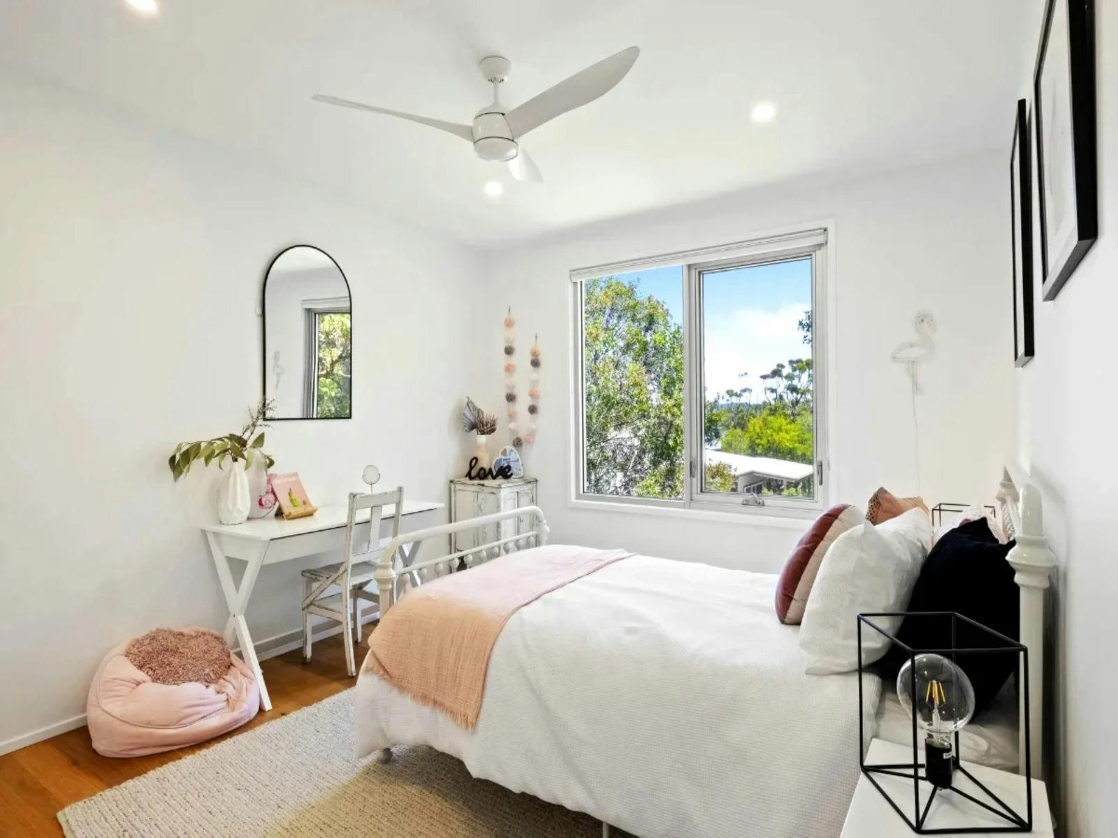 Comfortable single bedroom with modern furnishings and ample natural light