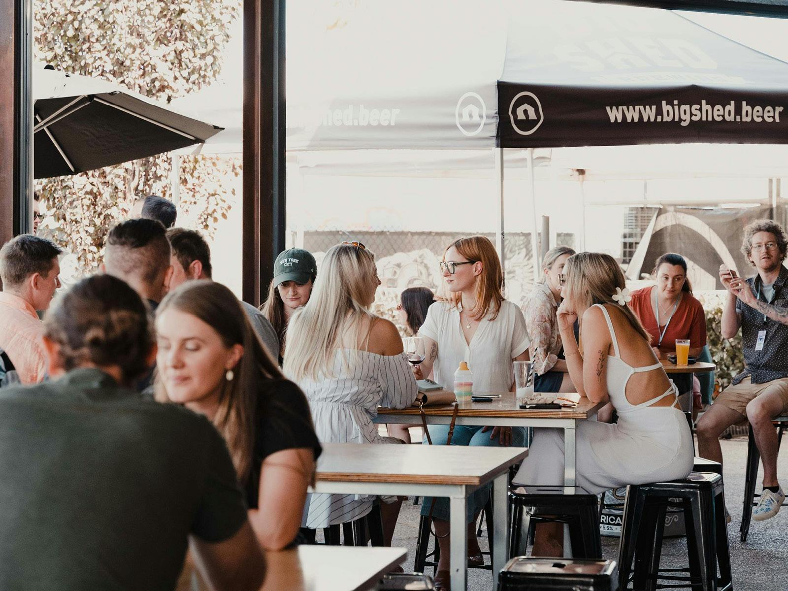 Customers sitting at tables in Beer Garden