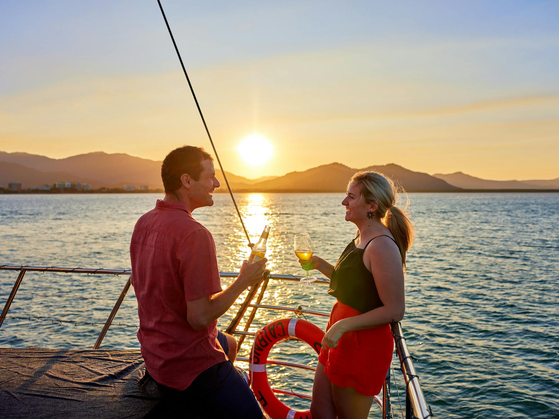 Couple cheers at Sunset