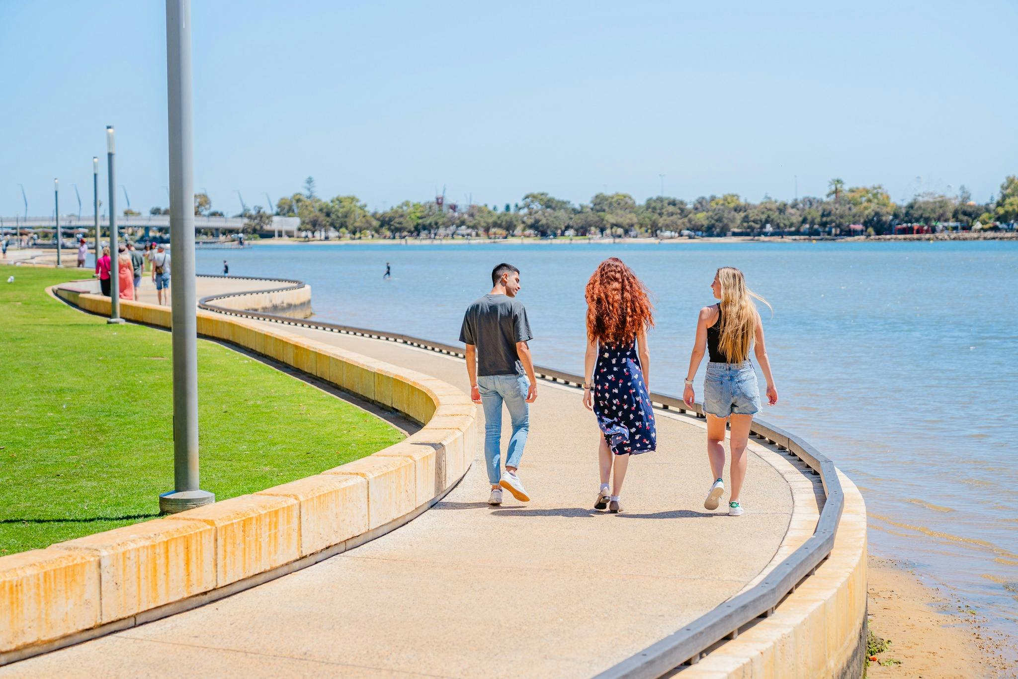 Friends strolling along Mandurah's Eastern Foreshore