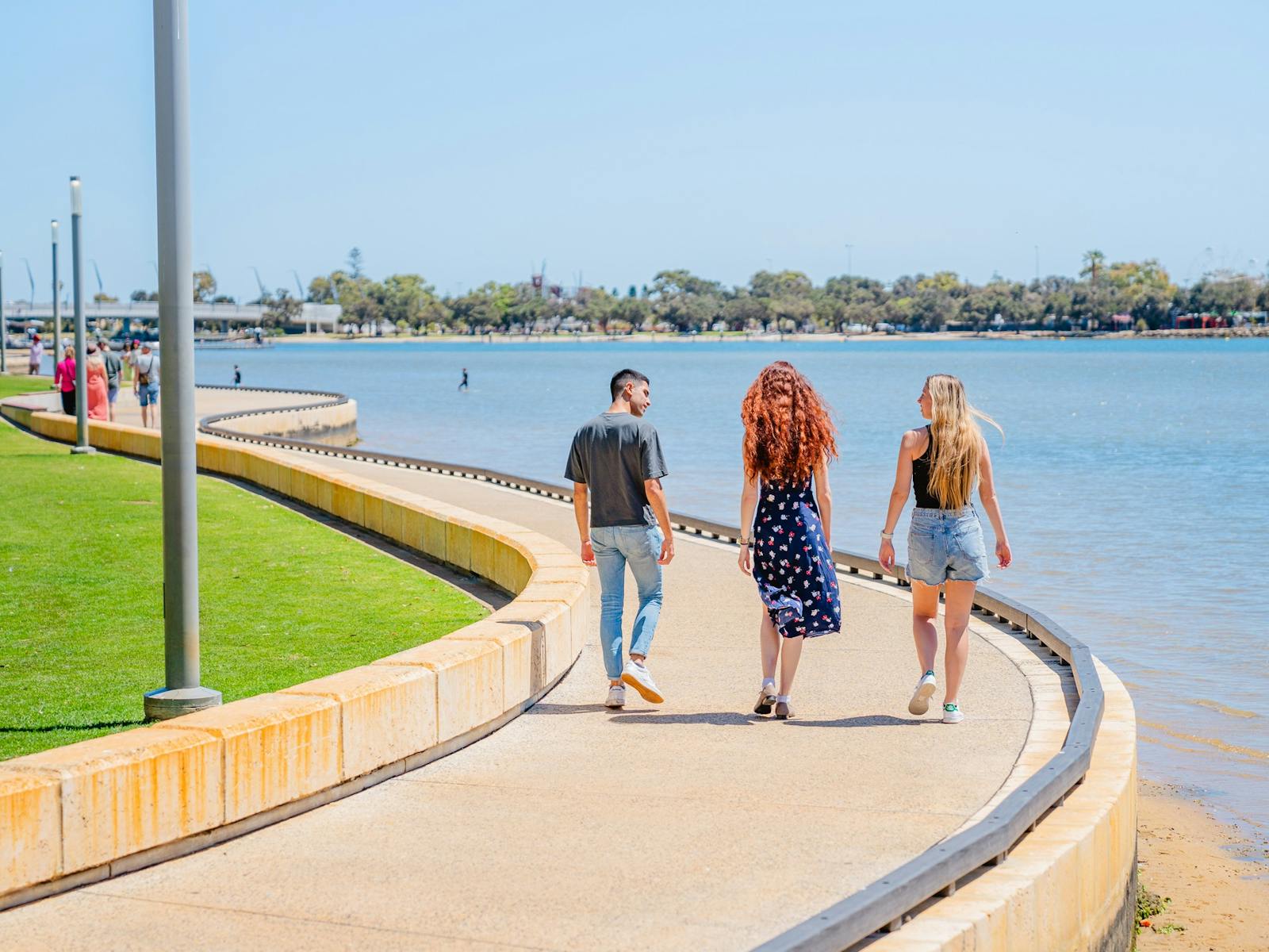 Friends strolling along Mandurah's Eastern Foreshore