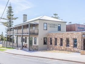 Tathra Hotel since 1888 - heritage listed building with stone wall