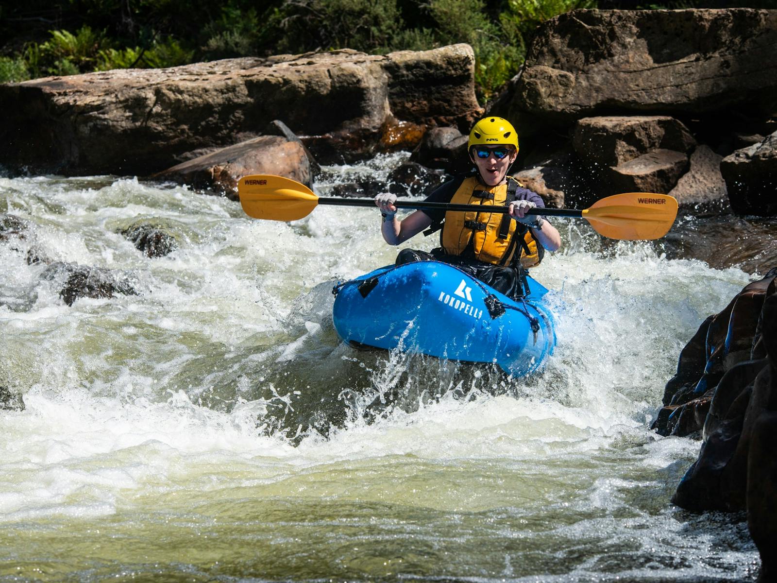 A packrafter paddles down rapids in Tasmania