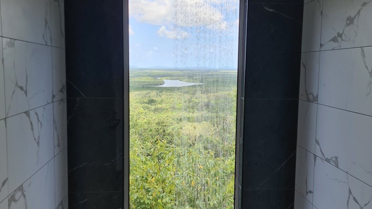 Full length window in the shower of the Mahogany Cabin