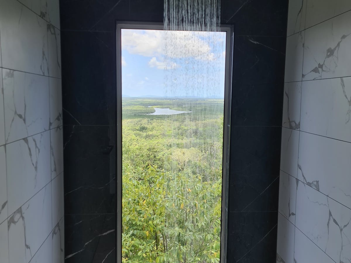 Full length window in the shower of the Mahogany Cabin