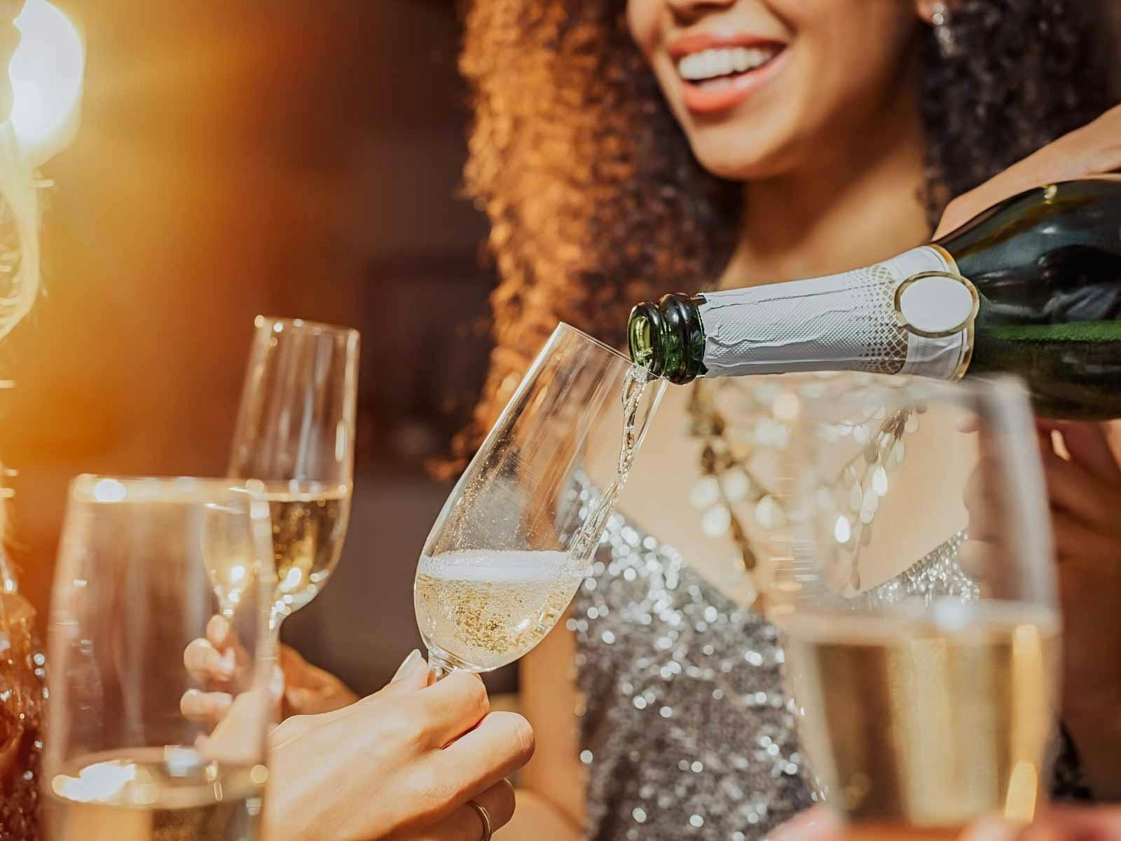 Smiles and glasses of champagne.