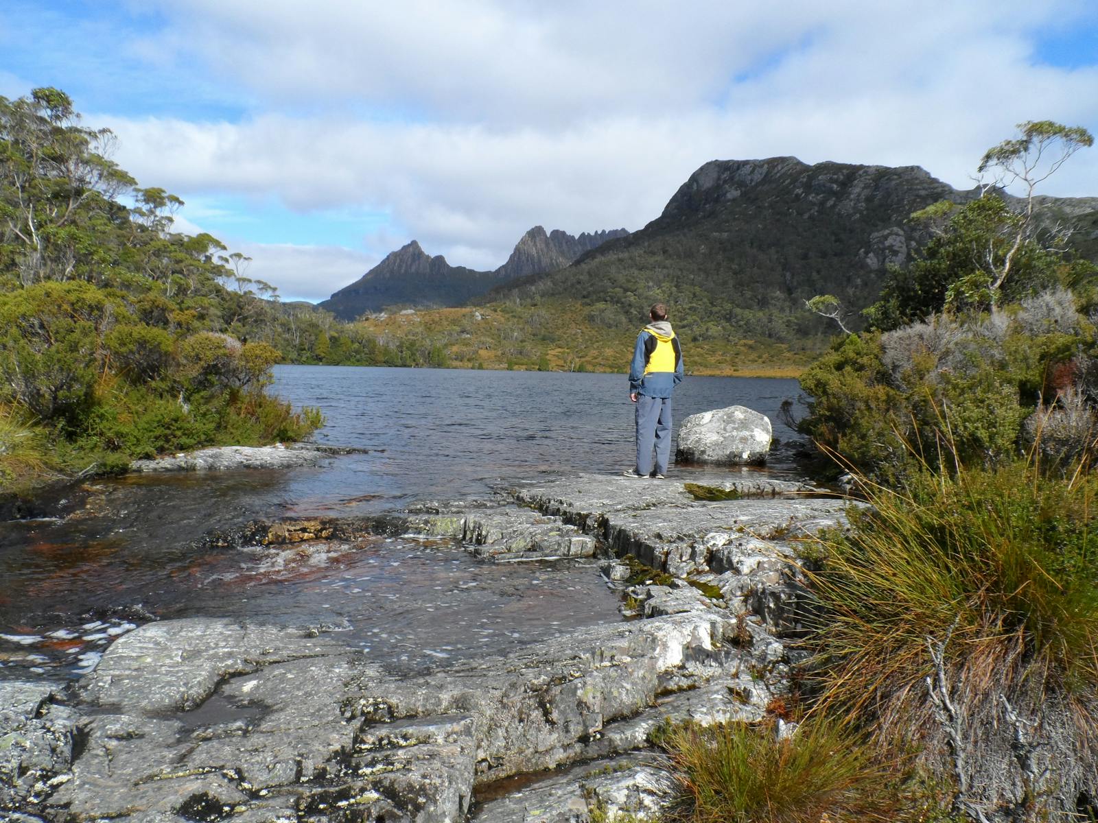 A guest admires Cradle Mountain from Lake Lila, water is very much part of the landscape in the Crad