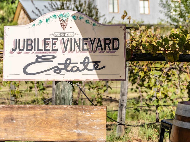 A bench seat with a Jubilee vineyard sign behind it
