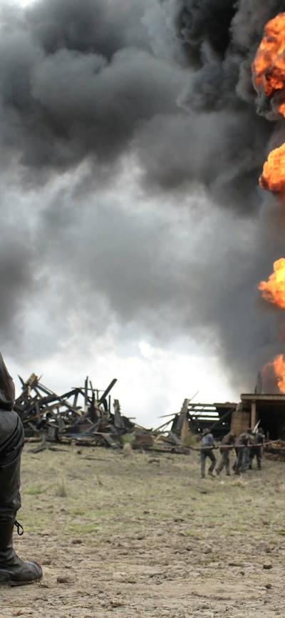 Man seated watching a firey explosion