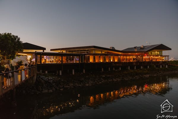 Salt House at night lit up with warm inviting light