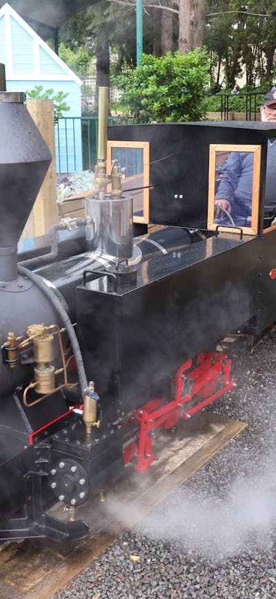 Steam is coming out of the miniature steam train