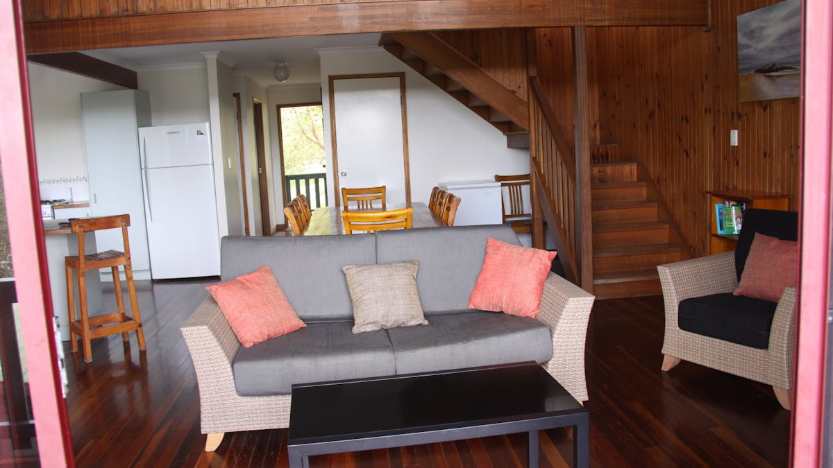Lounge room with cathedrafl ceiling where you can relax with views to ocean