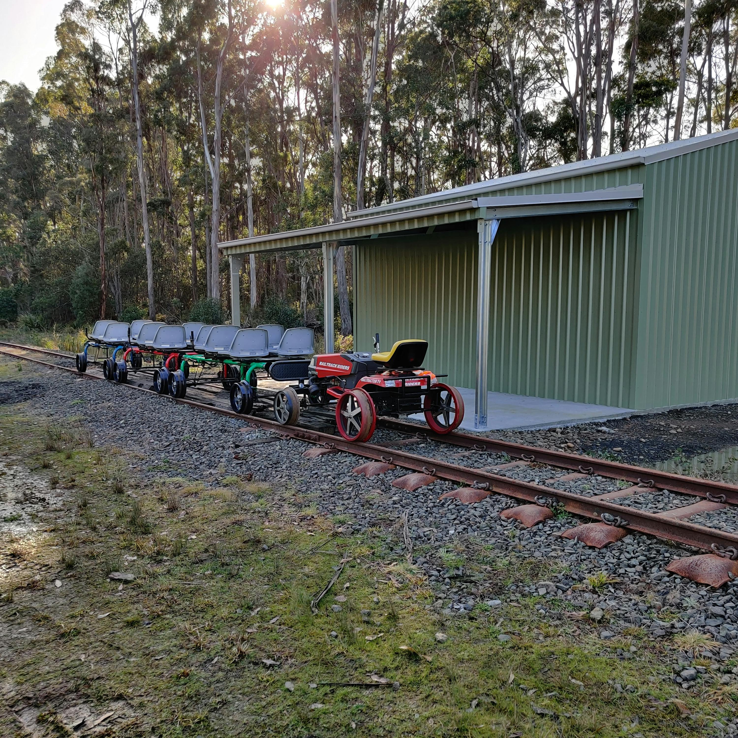 Railbugs  and escort vehicle by the railbug shed.