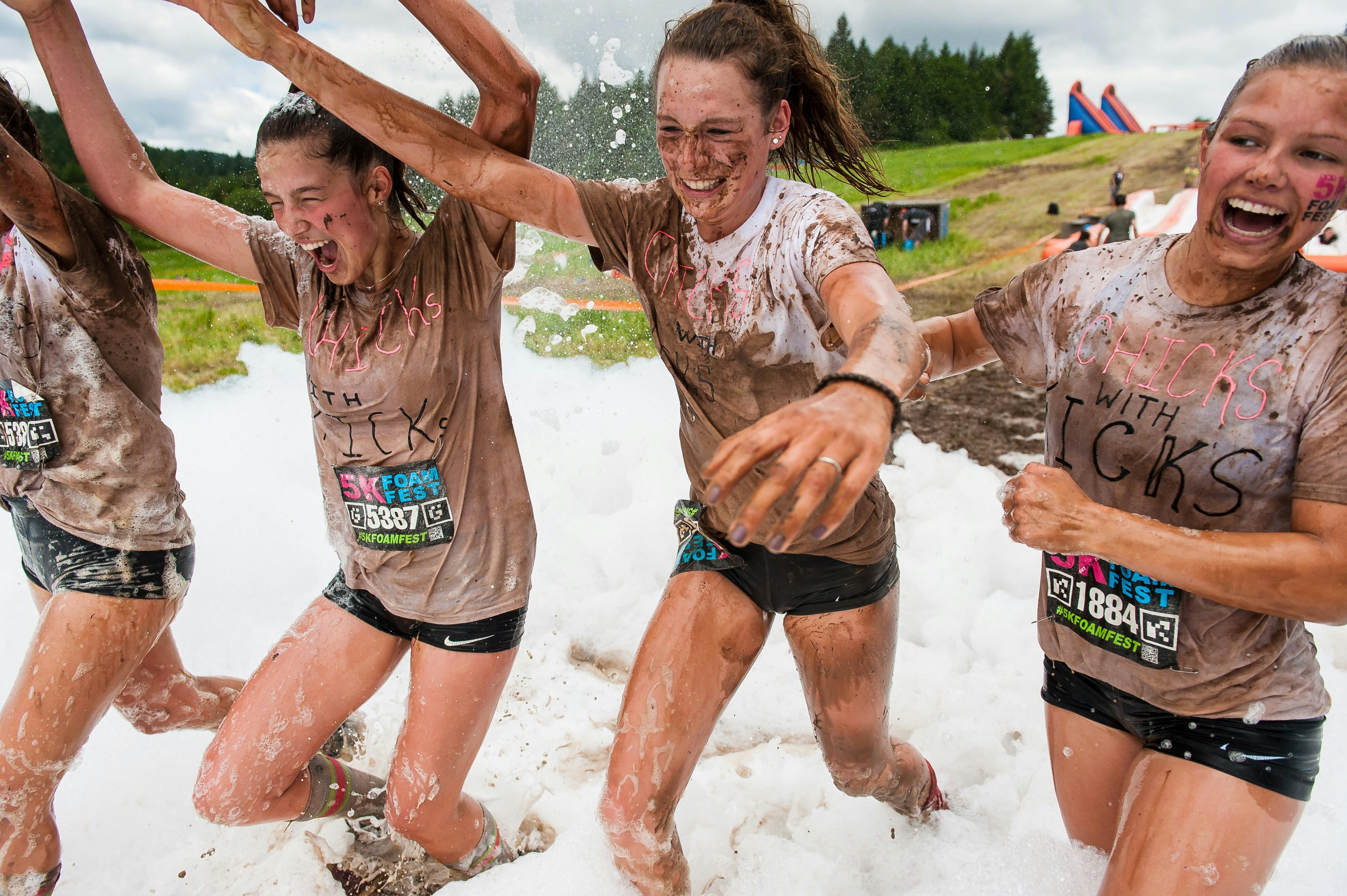 Friends crossing the foamy finish line together