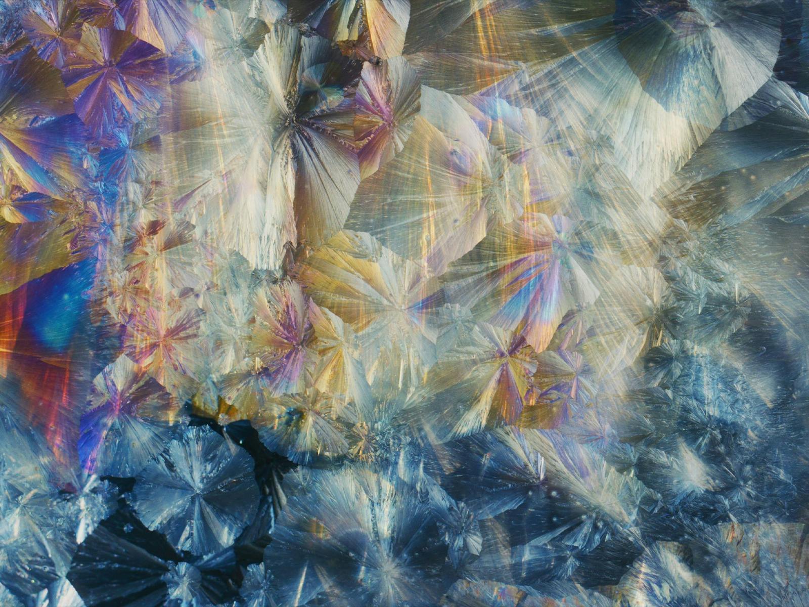 Close-up of iridescent blue, gold and purple crystalline formations.