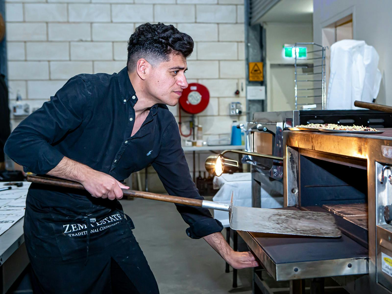 Demetrio Zema cooking pizza at Zema Estate