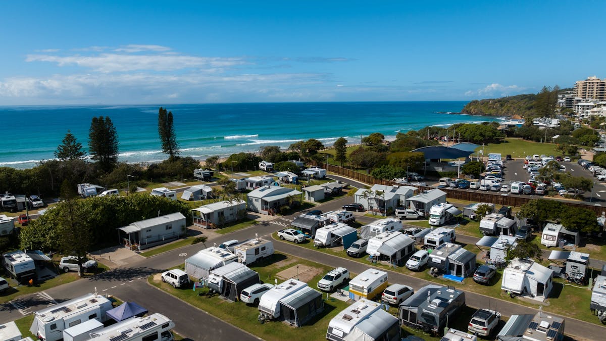 Arial shot of Coolum Beach Holiday Park with small views of the ocean but mainly showcasing caravans