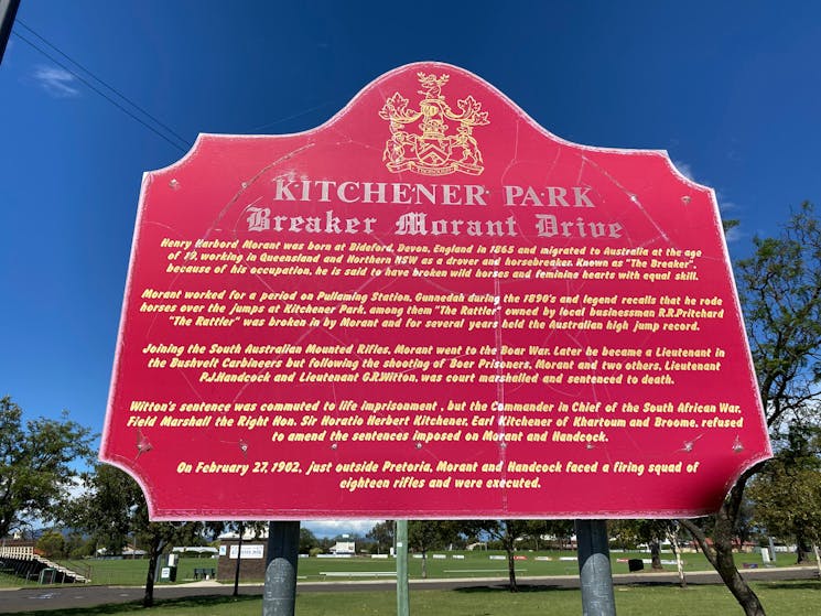 Red sign with white and gold writing telling Breaker Morant's story